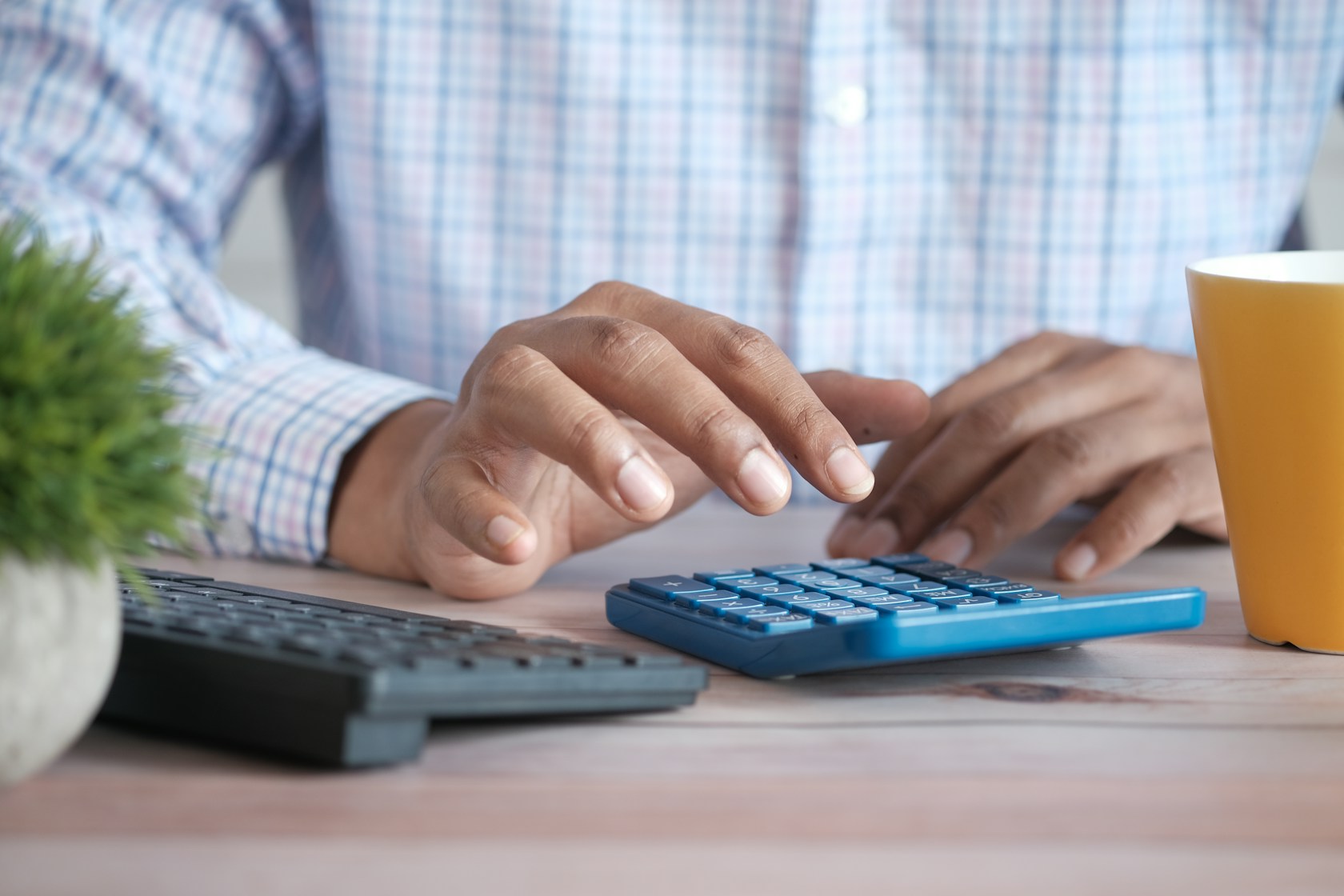 Desgravar la hipoteca en la renta: persona calculando la deducción por vivienda habitual con una calculadora